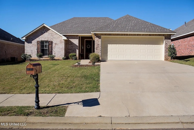 view of front of property with a garage and a front lawn