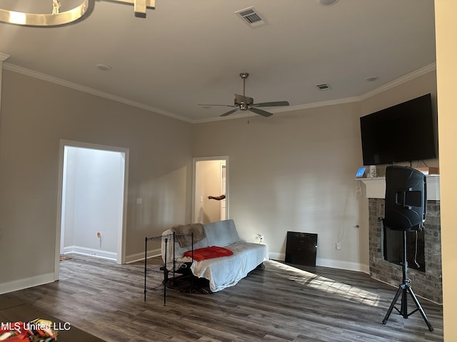 109 Brunswick Cv, Canton, MS 39046 - living room featuring ornamental molding, wood finished floors, baseboards, a ceiling fan, and a fireplace