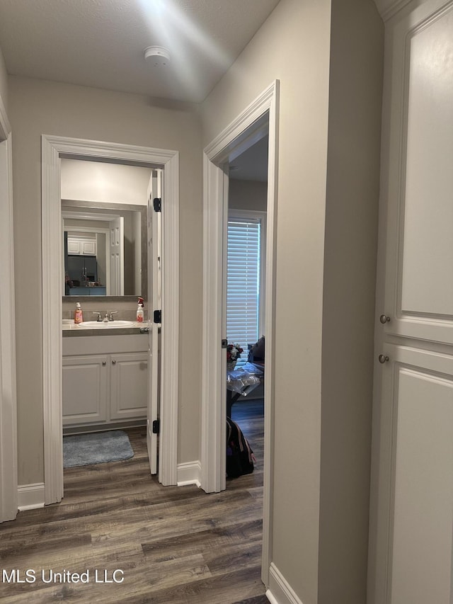 109 Brunswick Cv, Canton, MS 39046 - hallway featuring dark wood-style flooring and baseboards