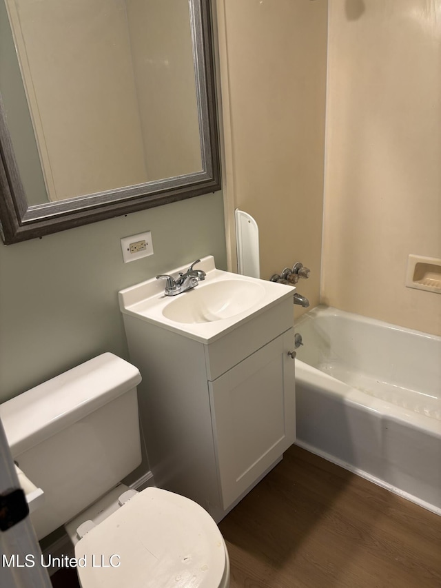 bathroom featuring vanity, hardwood / wood-style floors, and toilet