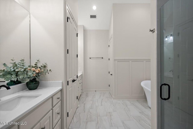 6603 Wirtz Rd, Flowood, MS 39232 - full bath featuring vanity, marble look tiles, a stall shower, a soaking tub, and a decorative wall