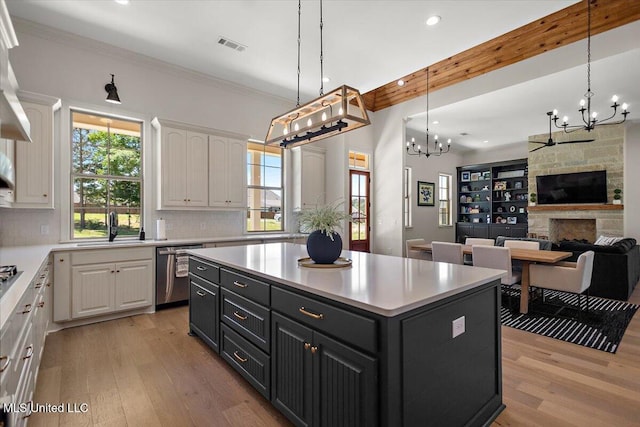 6603 Wirtz Rd, Flowood, MS 39232 - kitchen featuring dishwasher, a chandelier, white cabinetry, a sink, and light wood finished floors