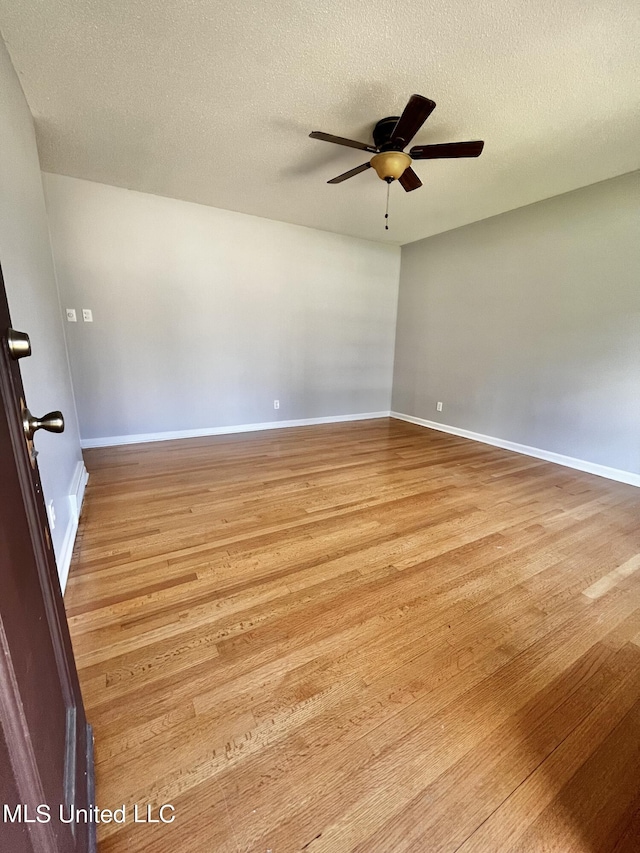 8301 Concord Cv, Southaven, MS 38671 - empty room with baseboards, a ceiling fan, light wood-type flooring, and a textured ceiling