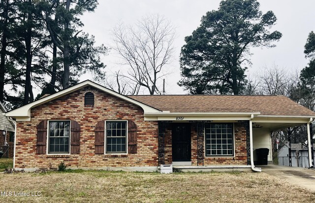 8301 Concord Cv, Southaven, MS 38671 - ranch-style house with a front yard, a carport, brick siding, concrete driveway, and a shingled roof