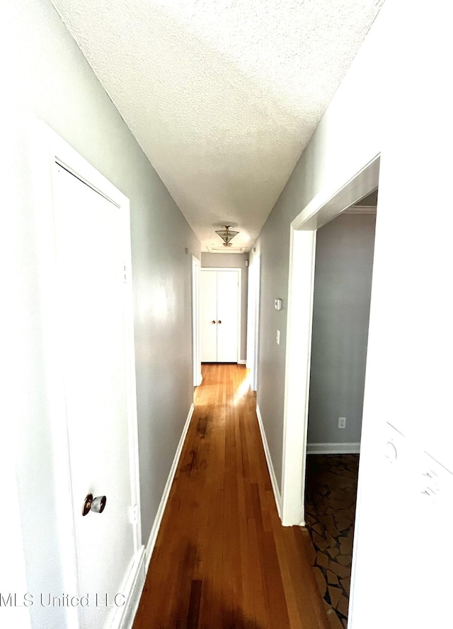 8301 Concord Cv, Southaven, MS 38671 - hallway featuring baseboards, a textured ceiling, and wood finished floors