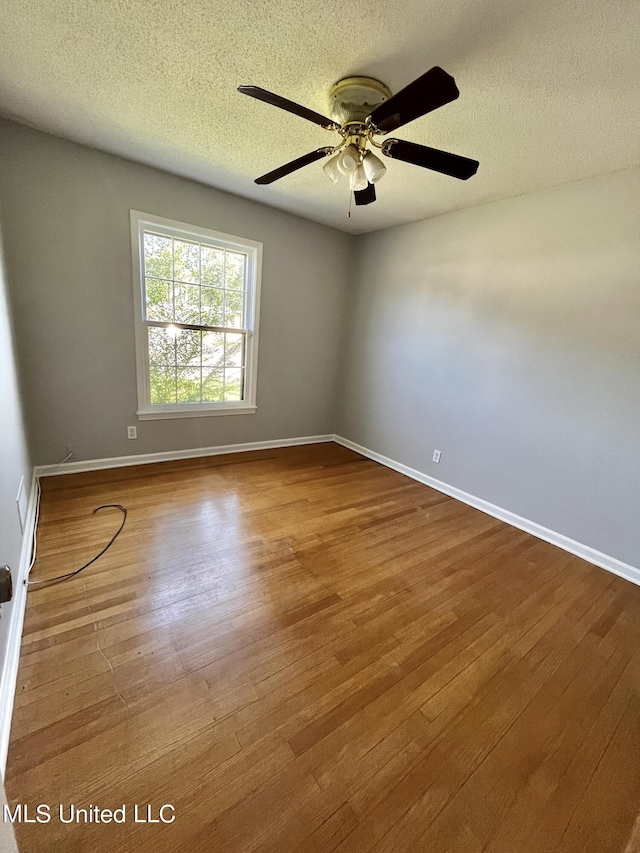 8301 Concord Cv, Southaven, MS 38671 - unfurnished bedroom with crown molding, a textured ceiling, baseboards, and wood finished floors