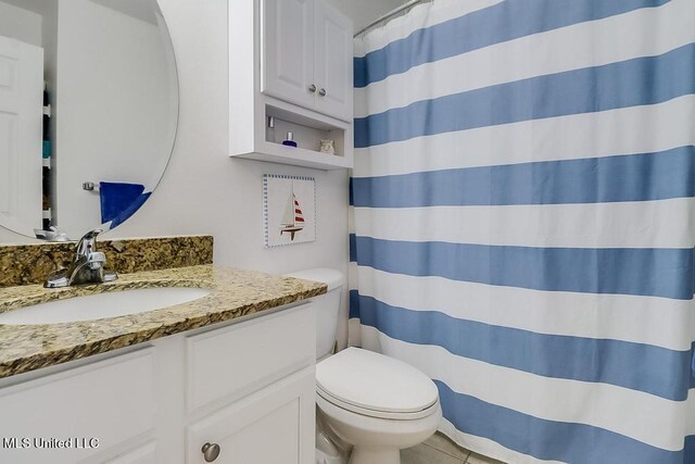 2421 Beachview Dr Unit D07, Ocean Springs, MS 39564 - bathroom with vanity, toilet, a shower with shower curtain, and tile patterned flooring