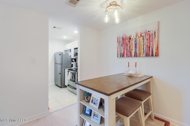 2421 Beachview Dr Unit D07, Ocean Springs, MS 39564 - dining room with baseboards and light tile patterned floors