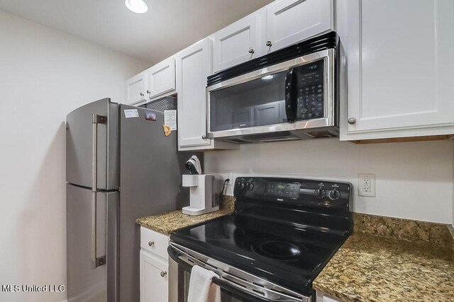 2421 Beachview Dr Unit D07, Ocean Springs, MS 39564 - kitchen with stainless steel appliances, white cabinets, and stone counters