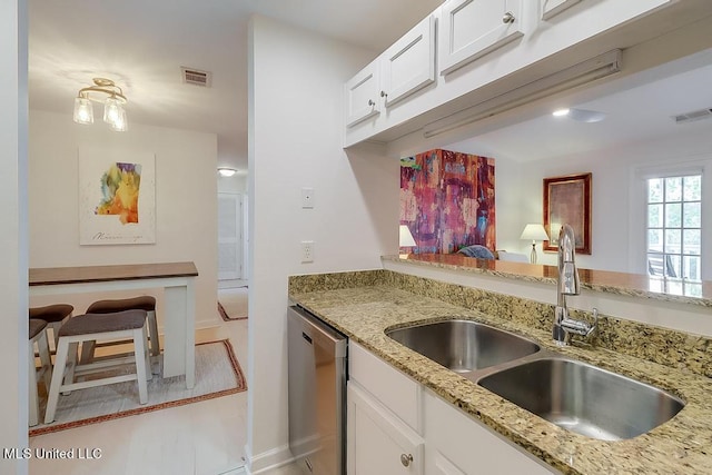 2421 Beachview Dr Unit D07, Ocean Springs, MS 39564 - kitchen with stainless steel dishwasher, a sink, white cabinets, and baseboards