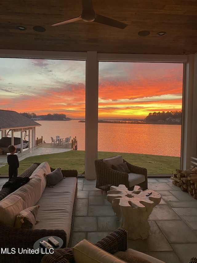 exterior space featuring a water view, ceiling fan, and an outdoor hangout area