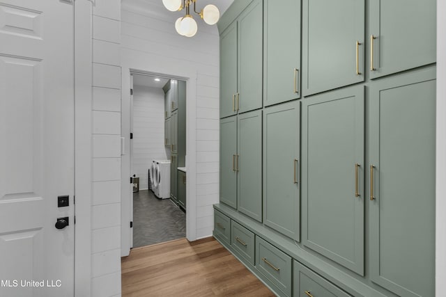 bathroom with washer and clothes dryer and wood finished floors