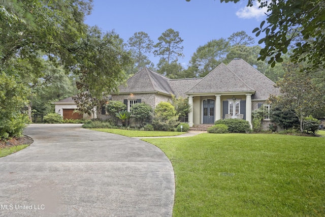 6416 Oliwa Pl, Diamondhead, MS 39525 - view of front of property featuring driveway, a front lawn, brick siding, and roof with shingles