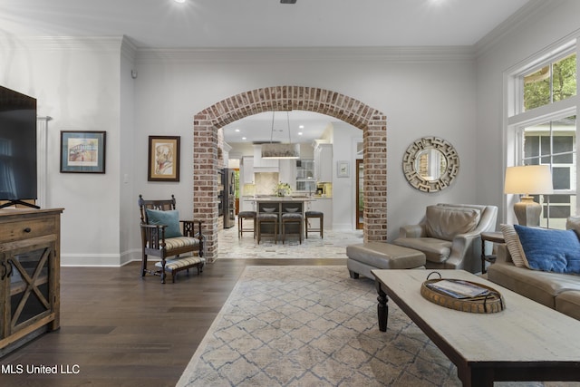 6416 Oliwa Pl, Diamondhead, MS 39525 - living room with arched walkways, dark wood-style floors, ornamental molding, and recessed lighting