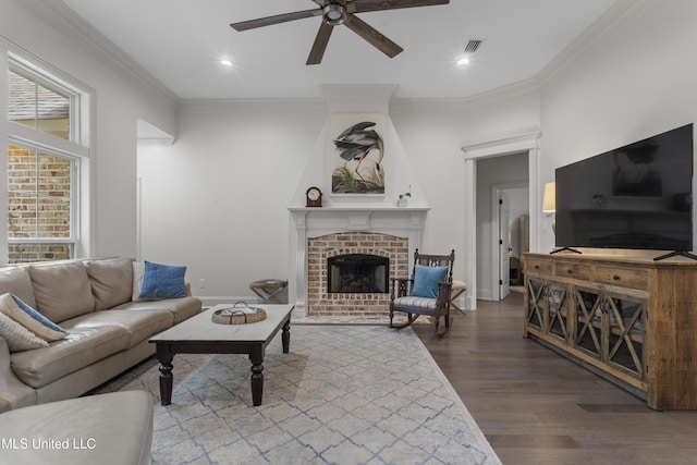 6416 Oliwa Pl, Diamondhead, MS 39525 - living room with a ceiling fan, wood finished floors, a brick fireplace, recessed lighting, and ornamental molding