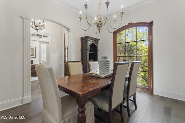 6416 Oliwa Pl, Diamondhead, MS 39525 - dining room with a chandelier, dark wood-style flooring, plenty of natural light, crown molding, and arched walkways