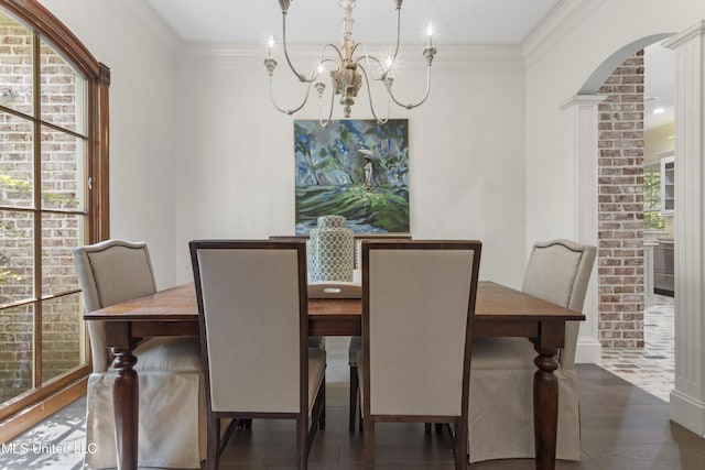 6416 Oliwa Pl, Diamondhead, MS 39525 - dining area with arched walkways, a chandelier, wood finished floors, and crown molding