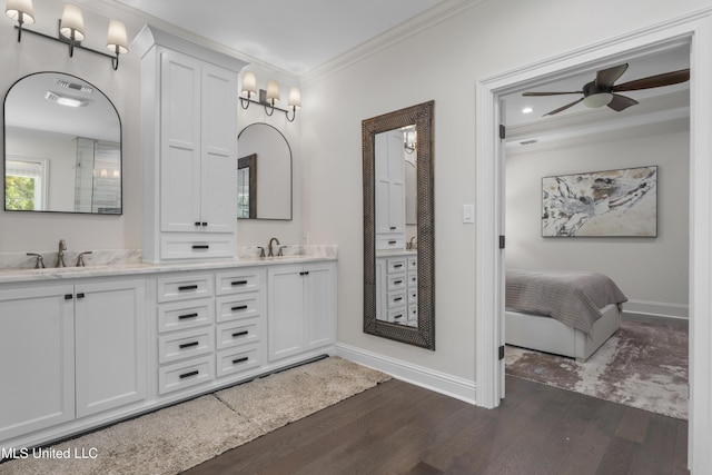6416 Oliwa Pl, Diamondhead, MS 39525 - bathroom with wood finished floors, crown molding, double vanity, ceiling fan, and recessed lighting