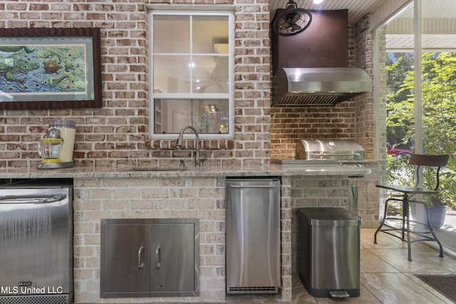 6416 Oliwa Pl, Diamondhead, MS 39525 - detailed view of wall chimney range hood and stainless steel dishwasher