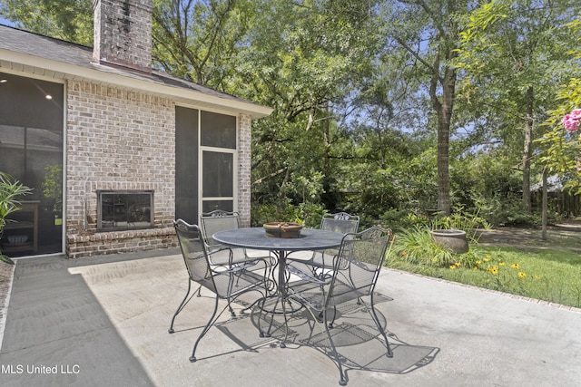 6416 Oliwa Pl, Diamondhead, MS 39525 - view of patio with outdoor dining space and view of scattered trees
