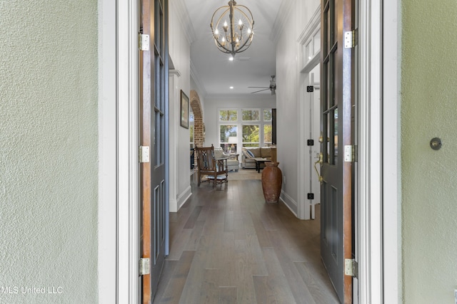 6416 Oliwa Pl, Diamondhead, MS 39525 - hall featuring crown molding, a chandelier, a textured wall, and wood finished floors