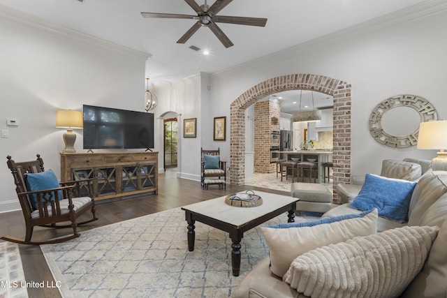 6416 Oliwa Pl, Diamondhead, MS 39525 - living room featuring arched walkways, ceiling fan, wood finished floors, ornamental molding, and recessed lighting