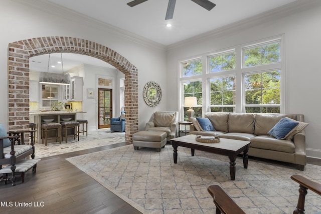 6416 Oliwa Pl, Diamondhead, MS 39525 - living room featuring arched walkways, crown molding, a ceiling fan, wood-type flooring, and recessed lighting