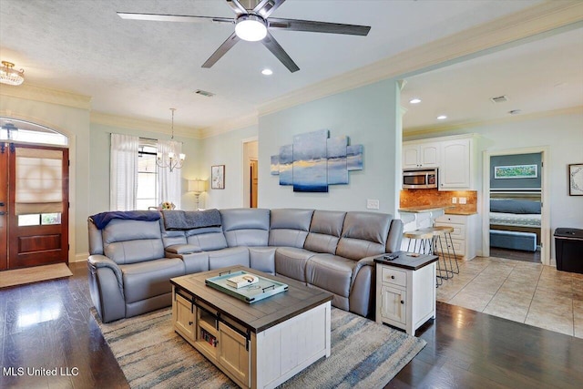 159 Stillhouse Creek Dr, Madison, MS 39110 - living area with a chandelier, light wood finished floors, a ceiling fan, crown molding, and recessed lighting