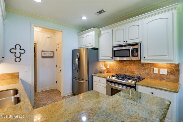 159 Stillhouse Creek Dr, Madison, MS 39110 - kitchen with stainless steel appliances, ornamental molding, backsplash, white cabinets, and recessed lighting