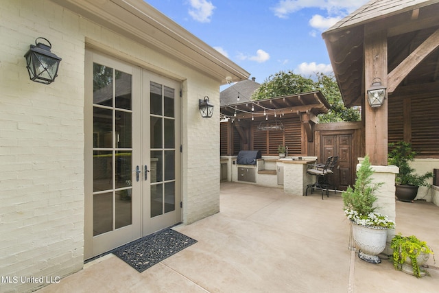 view of patio featuring french doors, a pergola, and area for grilling