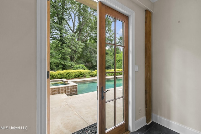 doorway featuring dark tile patterned flooring