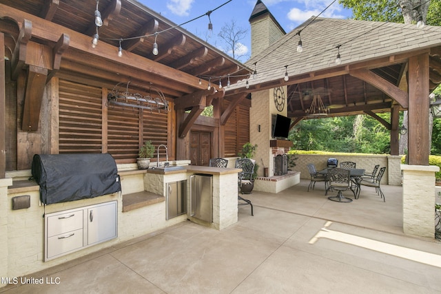 view of patio featuring a gazebo, ceiling fan, an outdoor bar, area for grilling, and a grill