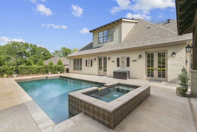 view of swimming pool featuring french doors, an in ground hot tub, and a patio area