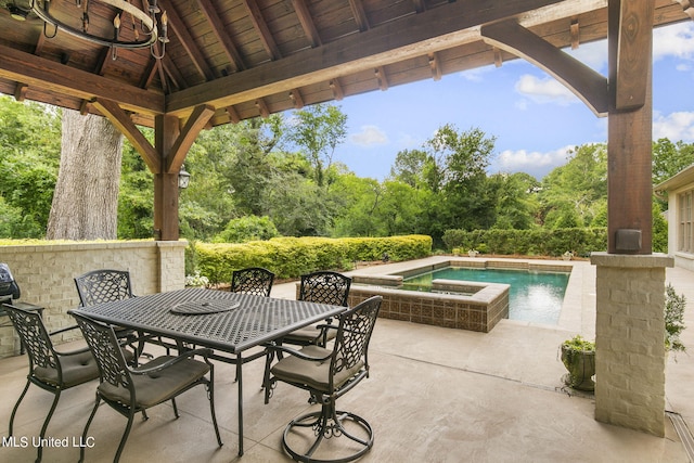 view of patio / terrace featuring a pool with hot tub