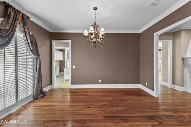 unfurnished dining area with crown molding, hardwood / wood-style flooring, and a chandelier