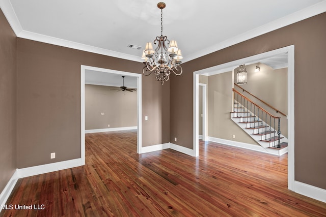 spare room featuring crown molding, hardwood / wood-style floors, and ceiling fan with notable chandelier