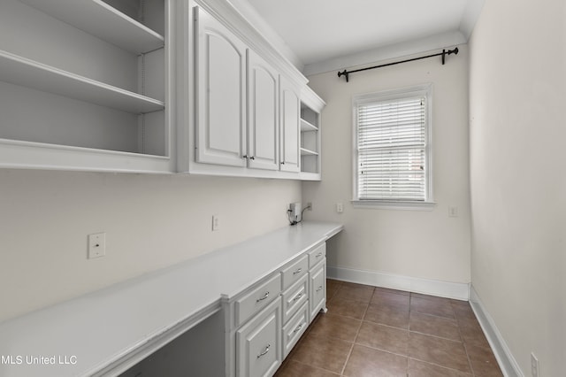 laundry area with dark tile patterned floors