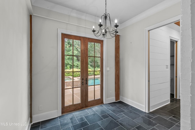 entryway featuring french doors and a notable chandelier