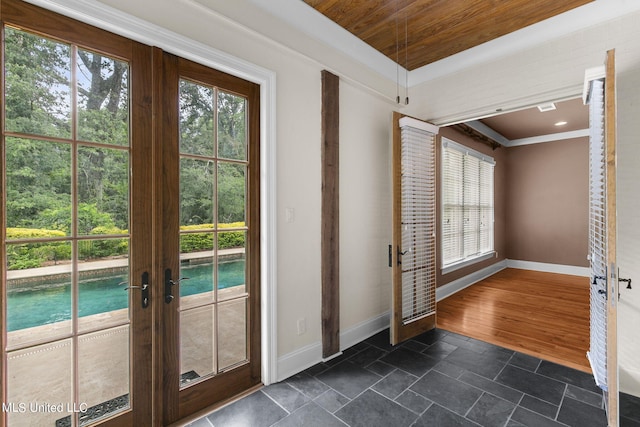 doorway with a wealth of natural light, ornamental molding, french doors, and dark hardwood / wood-style flooring