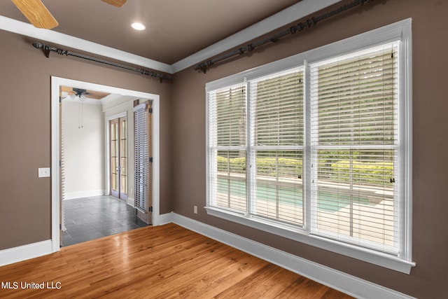 empty room with ceiling fan and wood-type flooring