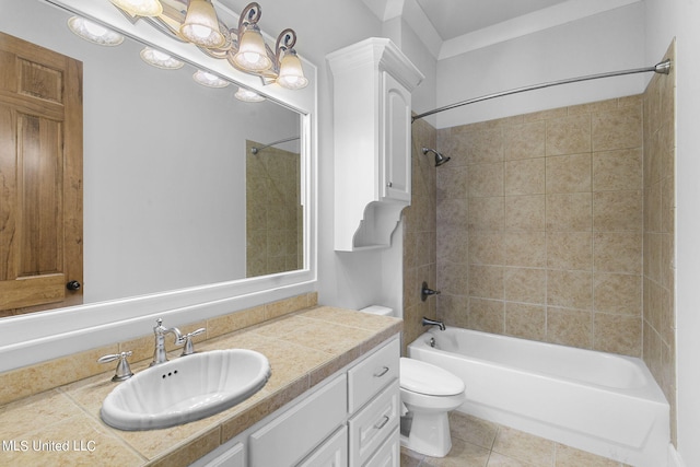 full bathroom with toilet, tiled shower / bath, vanity, and tile patterned floors