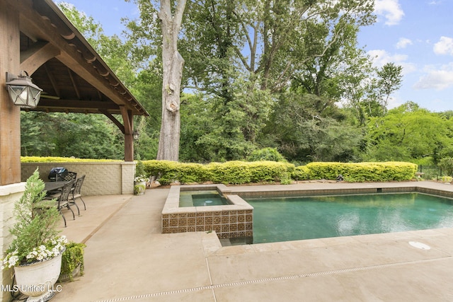 view of swimming pool featuring an in ground hot tub, a patio area, and a gazebo