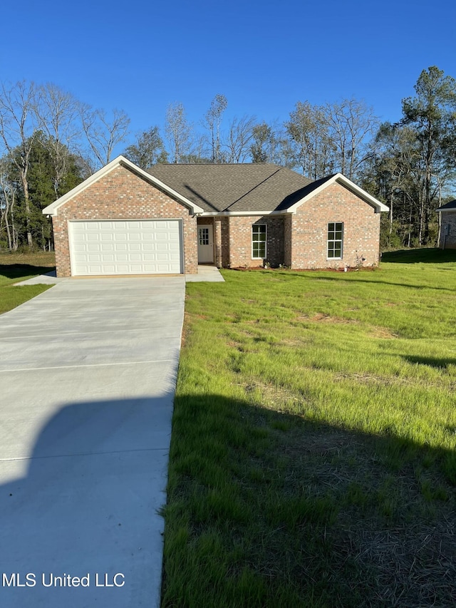 view of front of house with driveway, a front lawn, an attached garage, and brick siding