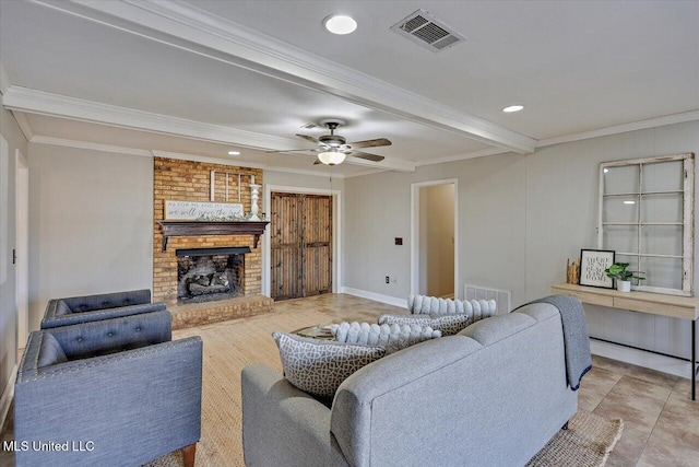 living room with a brick fireplace, visible vents, and ornamental molding