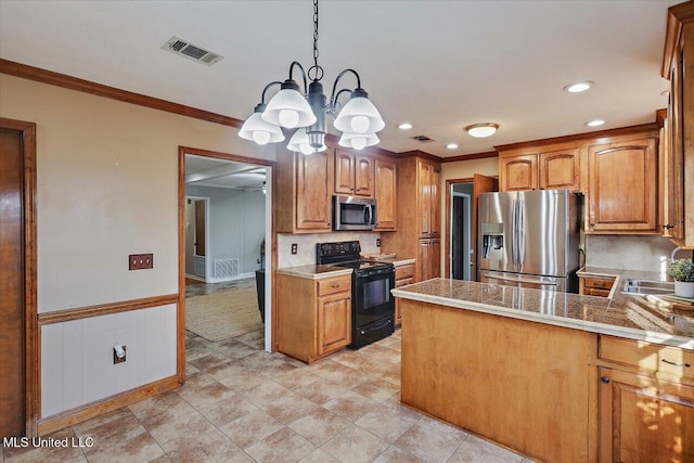 kitchen with visible vents, ornamental molding, hanging light fixtures, stainless steel appliances, and a sink