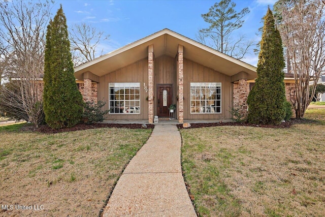 mid-century modern home with a front lawn