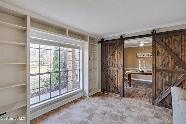 interior space featuring a barn door and crown molding