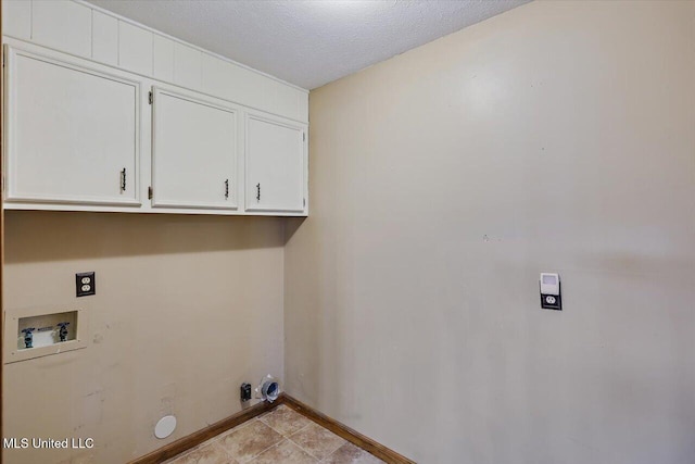 washroom with a textured ceiling, hookup for a washing machine, hookup for a gas dryer, baseboards, and cabinet space