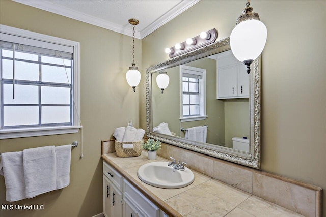 half bathroom featuring crown molding, vanity, and toilet