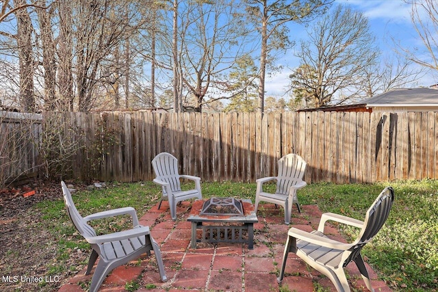 view of patio featuring an outdoor fire pit and a fenced backyard